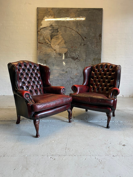 Exceptional Pair of Wing Back Chairs in Wine Reds & Matching Footstools