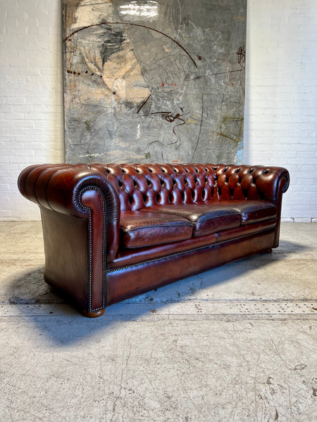 An Amazing Matching Pair of MidC Hand Dyed Leather Chesterfield Sofas Finished in A Cognac Wine