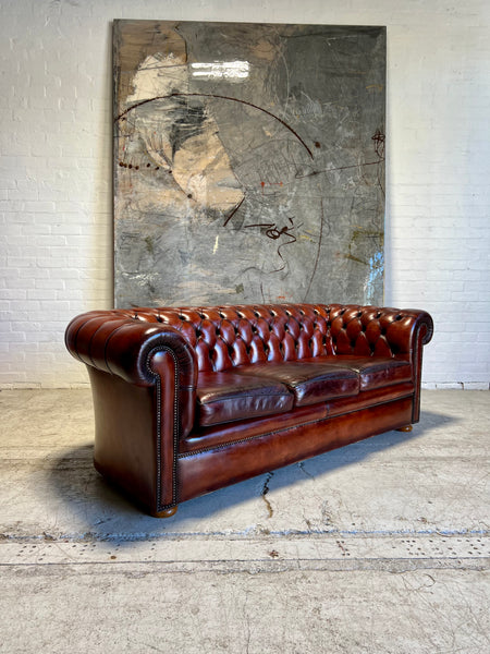 An Amazing Matching Pair of MidC Hand Dyed Leather Chesterfield Sofas Finished in A Cognac Wine