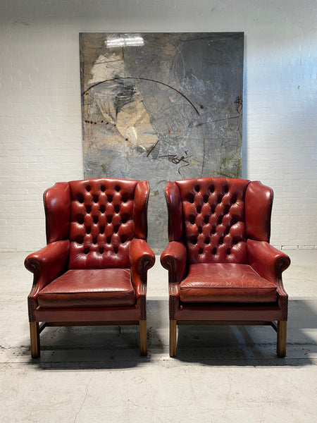 A Very Good Matching Pair of MidC Gentleman’s Wing Chairs in Raspberry Leather