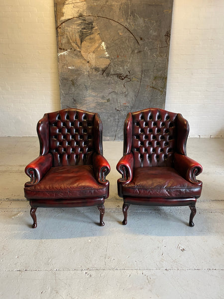 Exceptional Pair of Wing Back Chairs in Wine Reds & Matching Footstools