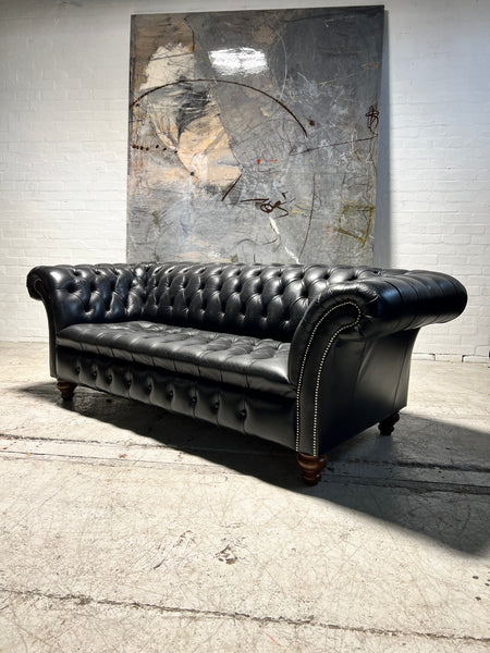 A Pair of Very Smart Black Leather Chesterfield Sofas