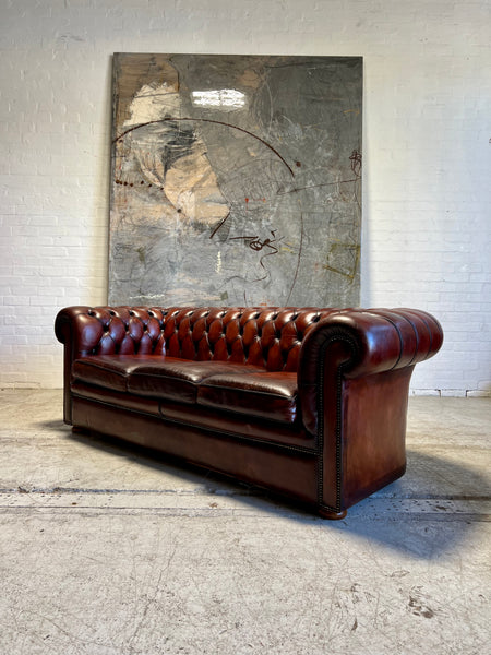 An Amazing Matching Pair of MidC Hand Dyed Leather Chesterfield Sofas Finished in A Cognac Wine